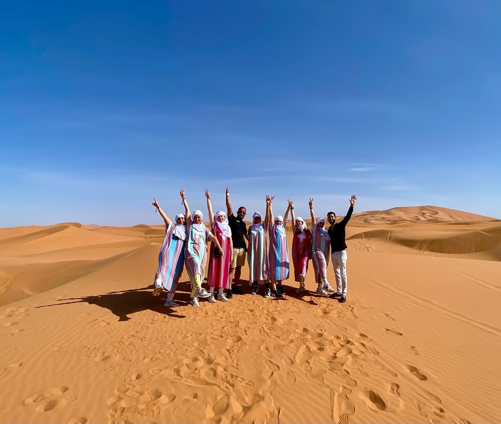 Guests celebrating on top of the dunes at Erg Chebbi